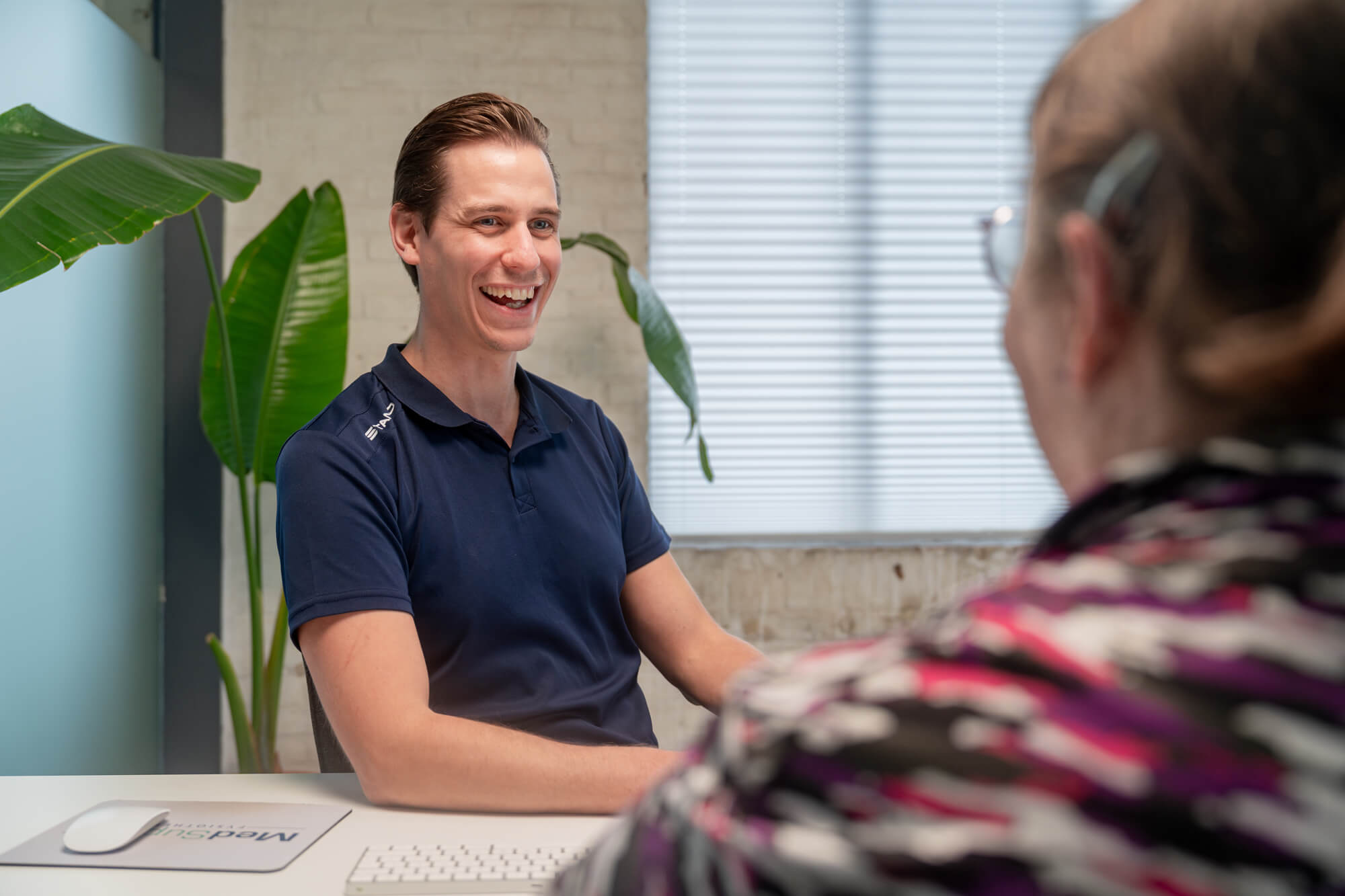 Fysio bij Fysiotherapie MedSupport in Zelhem die een gesprek heeft met een patiënt